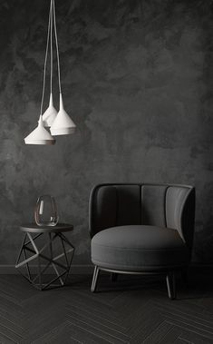 a chair, table and lamp in a room with concrete walls on the wall behind it