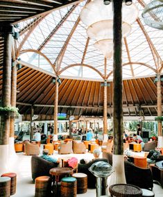 the inside of an outdoor restaurant with lots of tables and chairs in front of it