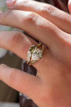 a close up of a person's hand with a ring on top of it