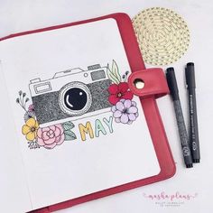 an open notebook with a camera on it