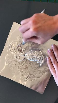 a person is drawing on a piece of paper