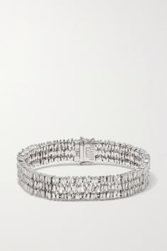 Suzanne Kalan's glamorous bracelet is designed to look like three stacked tennis styles in one. It's handmade from 18-karat white gold that beautifully accents the scattered baguette-cut diamonds, a signature of the designer. Keep it on reserve for special occasions. Luxury Platinum Diamond Bracelet With Baguette Diamonds, Fine Jewelry Platinum Tennis Bracelet With Baguette Diamonds, White Gold Bracelet With Baguette Diamonds, White Gold Diamond Bracelets With Baguette Diamonds, White Gold Bracelets With Baguette Diamonds, Luxury Platinum Jewelry With Baguette Diamonds, Platinum Bracelets With Baguette Diamonds In White Gold, Silver Tennis Bangle Bracelet With Baguette Diamonds, Luxury White Gold Tennis Bracelet With Baguette Diamonds