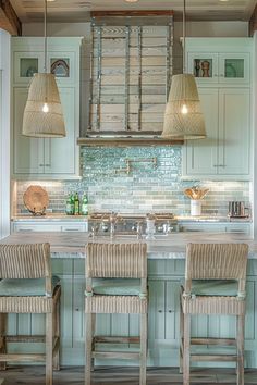 a kitchen with green cabinets and wooden stools in front of an island counter top