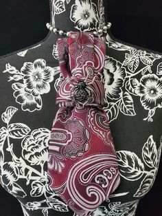 This Burgundy and White Paisley Necktie Necklace is made with a woven silk tie, and features a Black Rhinestone Spider Brooch strung on your choice of an adjustable Rosary Chain Ribbon Tie Pearl Necklace or an adjustable Elastic Band. The soft, comfortable fabric sits perfectly on any size chest, while the adjustable necklace feature allows you to customize the fit to your liking. Measuring at a versatile length, this necktie necklace is designed to be a one-size-fits-all. View all Women Tie's: Elegant Adjustable Red Neckwear, Elegant Red Adjustable Neckwear, Elegant Adjustable Formal Neckwear, Elegant Silver Tie As A Gift, Classic Jewelry With Ties For Parties, Elegant Red Neckwear For Gift, Elegant Red Neckwear As A Gift, Elegant Adjustable Neckwear For Gifts, Elegant Adjustable Neckwear As Gift