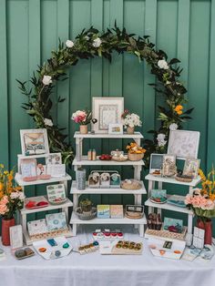 a table topped with lots of pictures and flowers