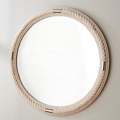 a round rope mirror hanging on the wall