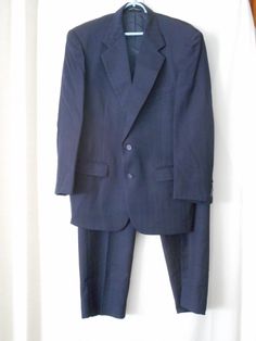 This is a Vintage Stafford Wool Suit - Navy with a pin stripe - has a Union Label so this is probably from the 80s Lined Jacket 2 front pockets; 1 breast pocket; 3 inside pockets  2 button front 4 button accent on  sleeves pants have 2 front pockets, 2 rear pockets 1 with a button There are no size tags so please check measurements: Approximate measurements: laying flat: Jacket: shoulder to bottom of sleeve 23 inches,  center back neck to bottom 30 inches, armpit to armpit across back 22 inches Pants - pleated 17.5 across waist; 40 inches top to bottom along side seam; 11.5 inch rise; 30 inch inseam (pants have 2.5 inches on the inside that could be used to make them longer) Tailored Striped Suits With Pockets, Classic Striped Suits With Pockets, Blue Striped Suit, Mod Suits, Blue Suit Men, Suit Pin, Button Fashion, Striped Wedding, Navy Blue Suit