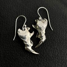 "One pair of rat jaw earrings, available in brass ($69) or sterling silver ($89). These jaws have a story. A friend in southern Arizona has a pair of great horned owls as neighbors. These owls perch on their home and trees regularly, and leave owl pellets all over the land. For those who don't know, owl pellets are the undigested parts of the bird's food, such as hair or bones, which are regurgitated (coughed up through the beak). There is often a full mouse or rat skull in each owl pellet, alon Handmade Sterling Silver Jewelry In Bone Color, Unique Bone Colored Sterling Silver Jewelry, Unique Bone-colored Sterling Silver Jewelry, Jaw Bone Jewelry, Mouse Bone Jewelry, Rat Skull, Owl Pellet, Bird Skull Earrings, Metal Skull Single Earring