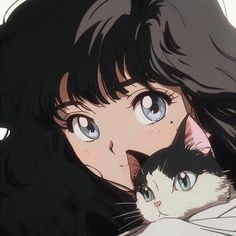 a woman holding a cat in her arms and looking at the camera with big blue eyes