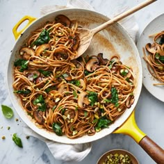 two pans filled with noodles and mushrooms