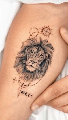 a woman's arm with a lion tattoo on it