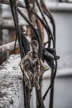 the rope is hanging from the boat's railing with an angel figurine on it