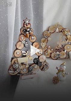 there is a small christmas tree made out of wooden slices and other decorations on the table