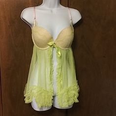 Nwt - Victoria Secrets Loc 1 Light Green Baby Doll With Push Up Bra That Has A Lace Overlay And Same Lace At The Adjustable Straps, Front Closure With Satin Ribbon That Hides It. Skirt Is A Netting That Falls Into Ruffles At The Hem And On The Split Opening In The Front. Size 36d. Mint Condition Tags Still Attached. Green Sheer Sleepwear, Sheer Green Sleepwear For Summer, Green Sheer Summer Sleepwear, Fitted Green Sleepwear With Lace Trim, Victoria Secrets, Green Baby, Lace Overlay, Push Up Bra, Satin Ribbon