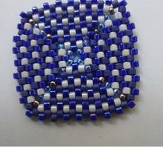 a blue and white beaded brooch