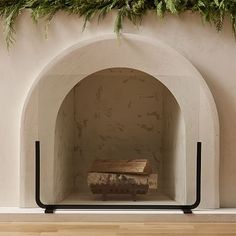 a fireplace with an arch and some plants on the top shelf in front of it