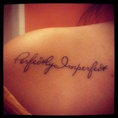 a woman's shoulder with the words perfectly imperfect written on her left upper arm