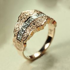 a gold ring with white diamonds on it