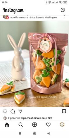 a bag filled with carrots sitting on top of a table next to a bunny figurine