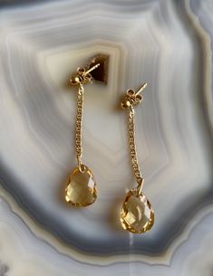 Delicate, feminine and so gorgeous! This is an 18k Gold Filled Earrings featuring a beautiful polished Citrine gemstone. You can see how clear is this stone’s cut. Amazing! Citrine is a great gem to wear to increase motivation! You will love how it will match a lot of your outfits! Product Details: . Size: 2” . Material: 18k Gold Filled Elegant Citrine Jewelry In Amber, Classic Teardrop Citrine Jewelry, Elegant Citrine Gemstones With Gemstone Accents, Elegant Drop Sterling Silver Gemstones, Elegant Sterling Silver Drop Gemstones, Elegant Drop Shaped Sterling Silver Gemstones, Elegant Drop-shaped Sterling Silver Gemstones, Elegant Drop Gemstone, Teardrop Jewelry With Si Clarity For Formal Occasions