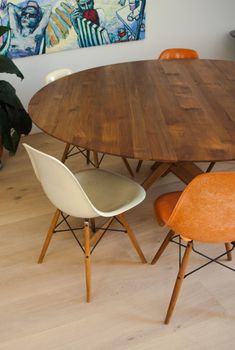 a wooden table with four chairs around it