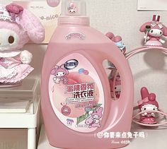 a pink bottle with hello kitty on it next to other items