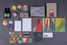 an assortment of stationery items are laid out on a gray surface, including notebooks and pens