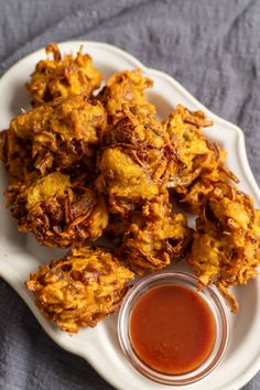 some fried food on a white plate with sauce