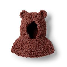 a crocheted teddy bear hat with a hole in the middle on a white background