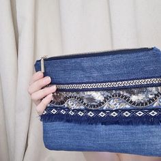 It's a small handmade Clutch in Boho style can be used as a cosmetics bag or pouch...
You can use with handle or without. It is a good gift for her!

This clutch made of dark and light blue recyceled jeans and decorated with golden braid and ribbon in Boho style.
This jeans bag is hold form and have a cotton linen with a small pocket inside.
Jeans ironed by adhesive interlining and seams are stitched.
Close on a very beautiful zipper.
This bag easily fits for a smartphone, purse and cosmetics. Golden Decor, Denim Clutch, Handmade Clutch, Recycled Jeans, Cosmetics Bag, Best Gifts For Her, Jeans Bag, Denim Bag, Boho Bag