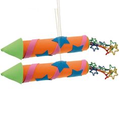 two orange and green rockets with stars on them