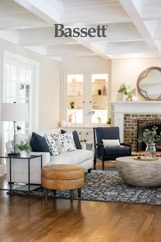 a living room filled with furniture and a fire place in the middle of a room