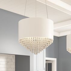 a chandelier hanging from the ceiling in a room with gray walls and white trim