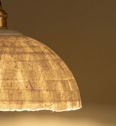 a light that is sitting on top of a table next to a lamp shade in the shape of a dome