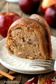 a slice of apple cinnamon bundt cake on a white plate with an apple in the background