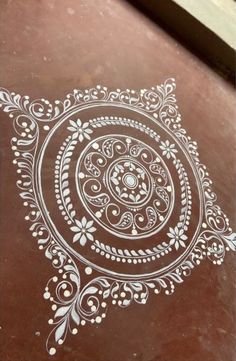 a brown table with white designs on it