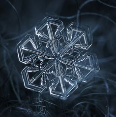 a snowflake that looks like it is made out of ice and has been placed on the ground