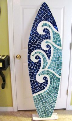 a blue and white surfboard sitting in front of a door