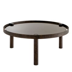 a round glass table with metal legs and an iron frame around the edge, against a white background