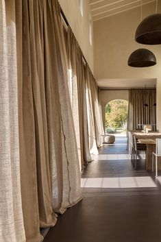 a long hallway with curtains hanging from the ceiling