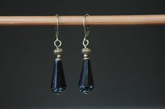 "These dangle earrings are made with black teardrop Czech glass beads. Teardrops are faceted and the color is a opaque jet black with a picasso finish on the rounded ends, giving them an extra touch of class. They are adorned with brass findings, hanging from antique brass lever backs ( lead and nickel free). Leverbacks keep your earrings on securely by creating a closed loop. They are lightweight, comfortable and easy to wear everyday. Color : Black Faceted Teardrop Czech glass beads (20x9mm ). Black Beaded Teardrop Earrings For Gift, Teardrop Black Beaded Earrings For Gift, Teardrop Black Beaded Earrings As Gift, Teardrop Earrings With Black Beads For Gifts, Elegant Teardrop Black Bead Earrings, Elegant Black Beaded Teardrop Earrings, Black Teardrop Crystal Earrings For Gift, Black Earrings Dangle, Earring Crafts