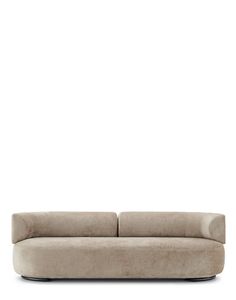 a beige couch sitting on top of a white floor