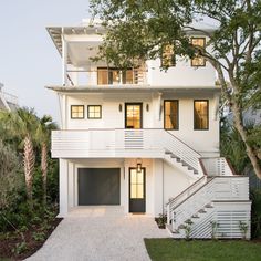 a white house with stairs leading up to it