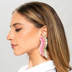 Step out in style with these Pink Gold statement Wing Earrings - a perfect balance of cuteness and elegance. Women will love the unique combination of whimsy and luxury with the playful baby pink hue and opulent golden tones. The one-of-a-kind earrings are designed in the shape of angel wings, adorned with layers of sequins arranged around a single stud. Be a true statement-maker with these handmade, beaded statement earrings. Size: Length: 3.5''/ Width: 1'' Pink Chandelier Earrings For Summer Party, Handmade Earrings For Spring Party, Trendy Pink Gold Jewelry For Party, Elegant Pink Chandelier Earrings, Pink Drop Earrings For Spring, Pink Chandelier Earrings For Gift, Handmade Trendy Rose Gold Earrings, Trendy Pink Drop Earrings, Feminine Pink Earrings For Spring