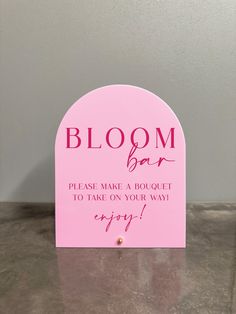 a pink sign that says bloom bar please make a bouquet to take on your way