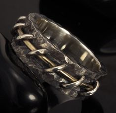 a silver ring sitting on top of a black table