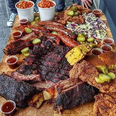 a wooden cutting board topped with lots of meat