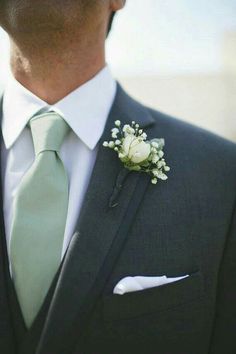 a man in a suit and tie with a boutonniere on his lapel