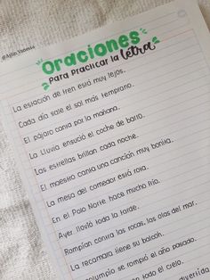 a close up of a piece of paper on a bed with writing in spanish and english