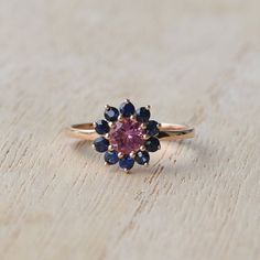 A stunning ring with pink tourmaline and blue sapphires made out of 14k solid gold . The weight of the ring is approx. 2.63g. High polished. This romantic piece of jewelry is a great extraordinary gift and would make a perfect choice for the engagement. You can choose between 14k rose, yellow or white gold. If you want to customise this product or set it with another stones - please write to us. ❤ Hand Made with love in our studio in Prague ❤ Stone details Tourmaline Shape: Round Dimensions: 5 m Pink Gold Sapphire Ring With Gemstone, Pink Multi-stone Sapphire Ring, Fine Jewelry, Pink Multi-stone Sapphire Ring, Pink Sapphire Ring Birthstone Fine Jewelry, Pink Multi-stone Sapphire Ring In Fine Jewelry Style, Pink Sapphire Ring In 14k Gold With Prong Setting, Pink Tourmaline Sapphire Ring, Pink Sapphire Gemstone Rings, Pink Multi-stone Sapphire Promise Ring